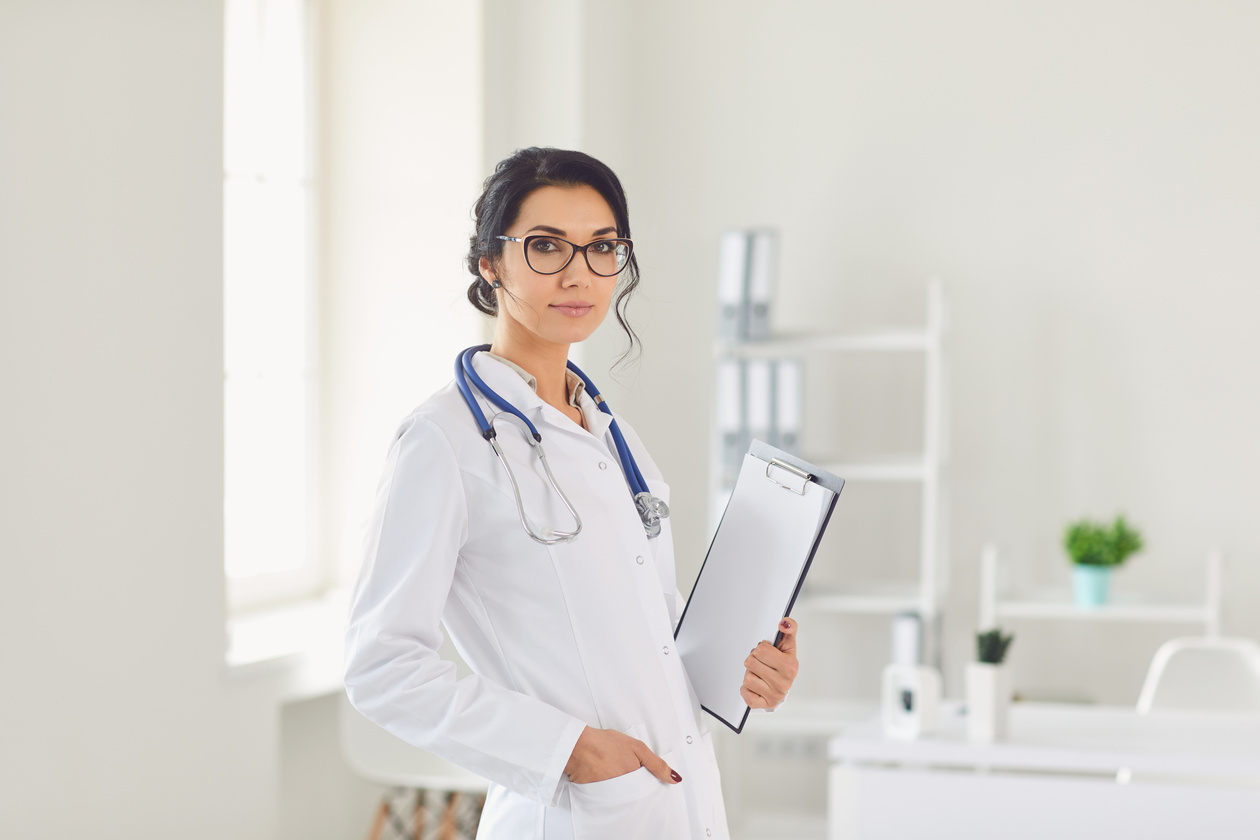 Professional Female Doctor with Clipboard in Office